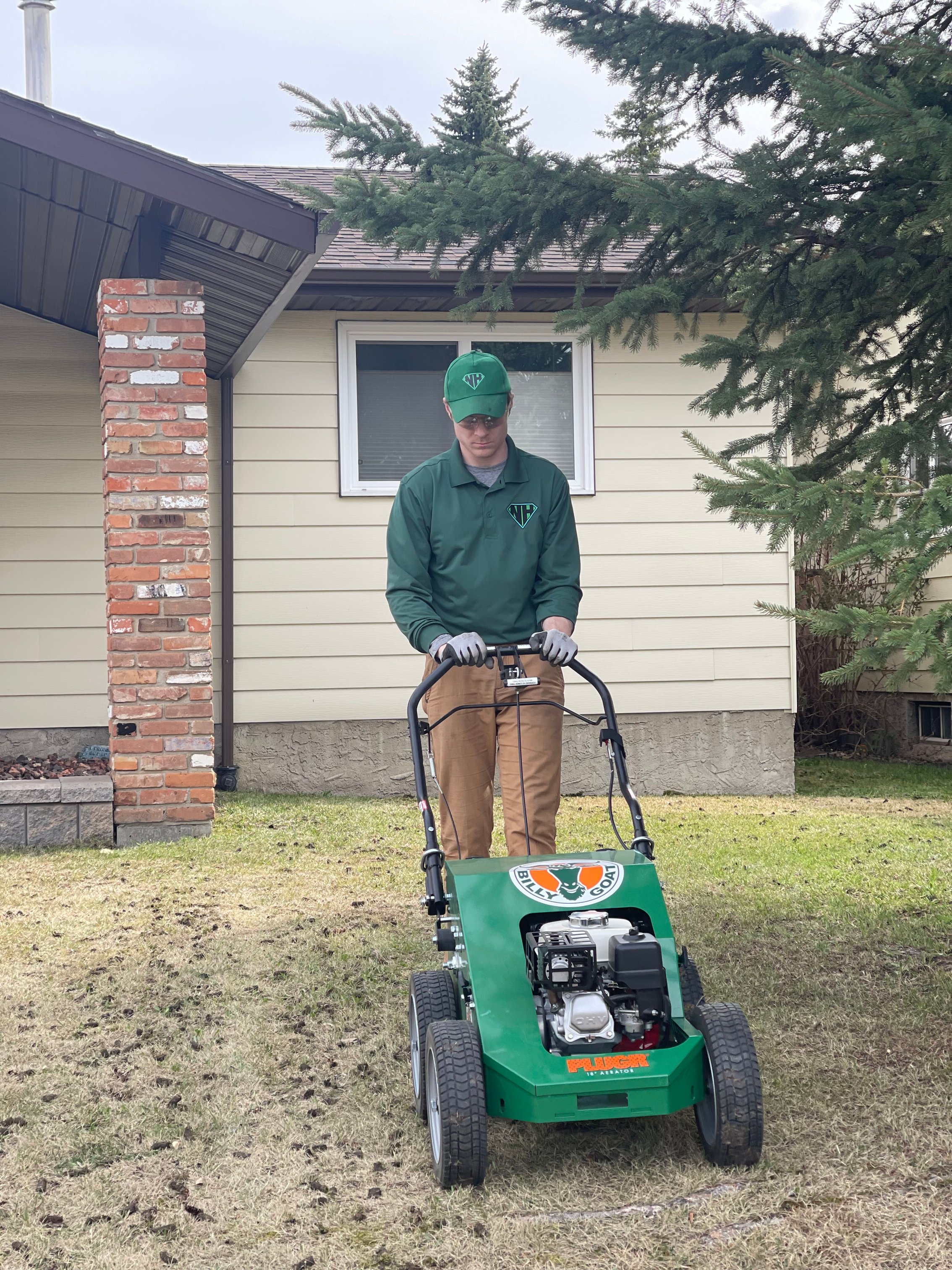 Neighbourhood Heroes performing an Aeration in windermere edmonton